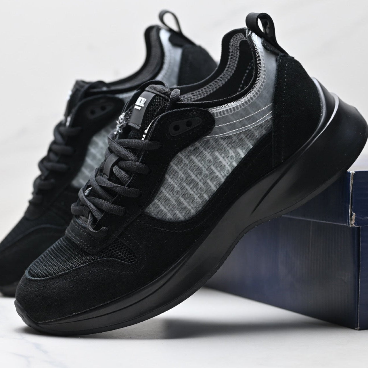 Black sneakers with a textured design on a white background